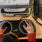 Woman sitting at computer using specialized equipment