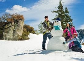 Family building a snowman.