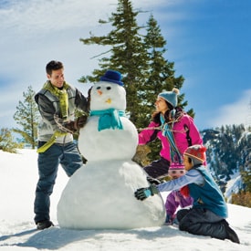 A cropped photo of the family building a snowman