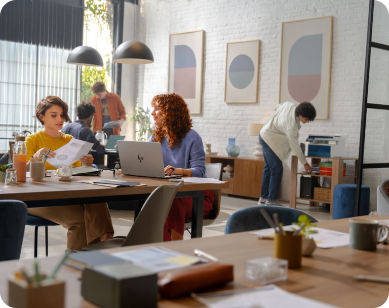 Two female professionals in modern office collaborating at workspace with a HP Z2 Tower G1i Workstation Desktop PC