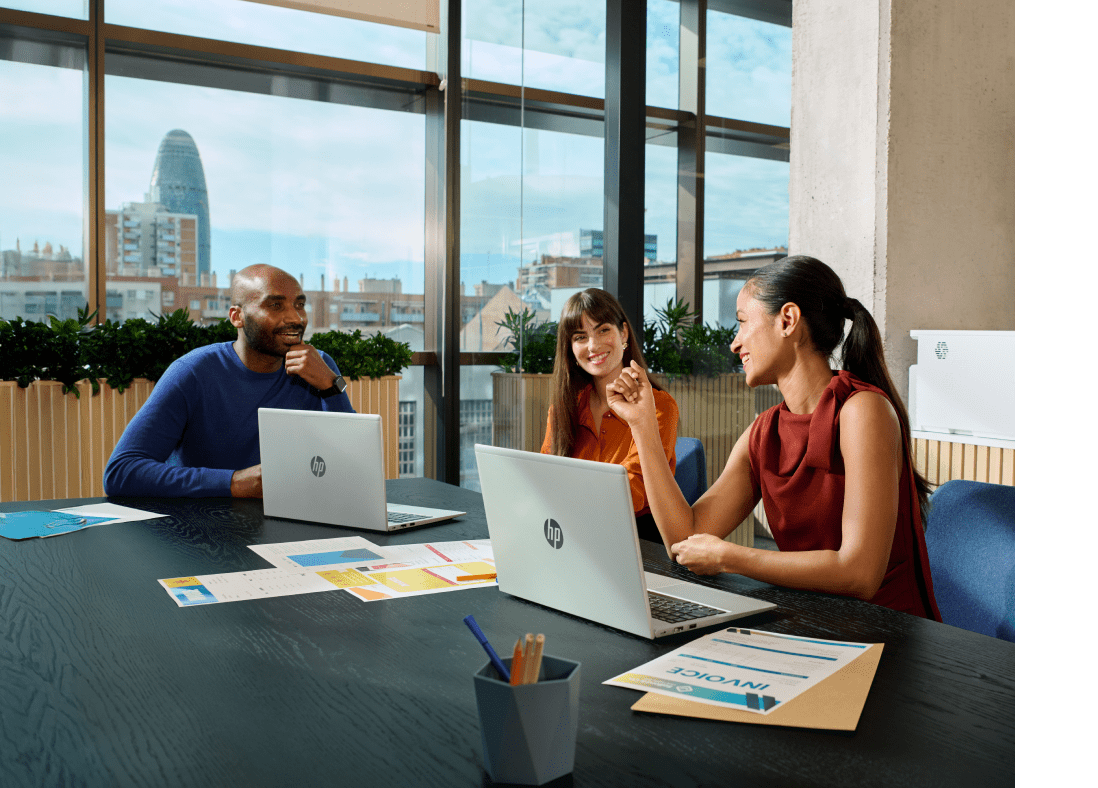 Close image of professional male in modern office with blue ambient lighting, working at HP laptop