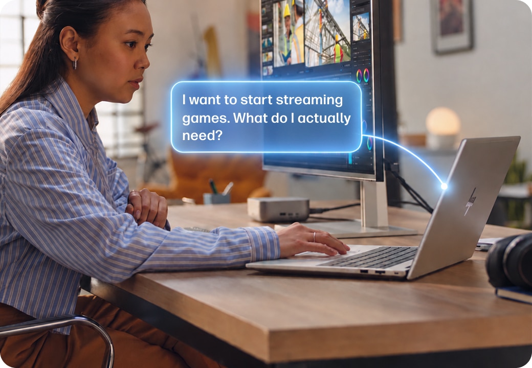 Person on a laptop with "I want to start streaming games. What do I actually need" prompt in a blue bubble.
