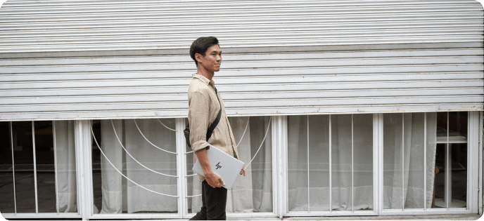 Lightweight OmniBook carried in a modern setting, reflecting freedom to work longer without plugging in.
