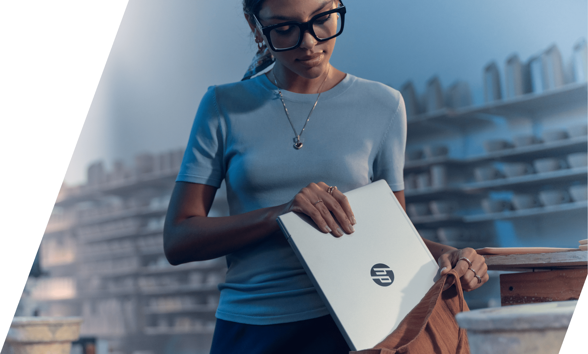 A woman placing an HP ProBook 4 into a bag.​