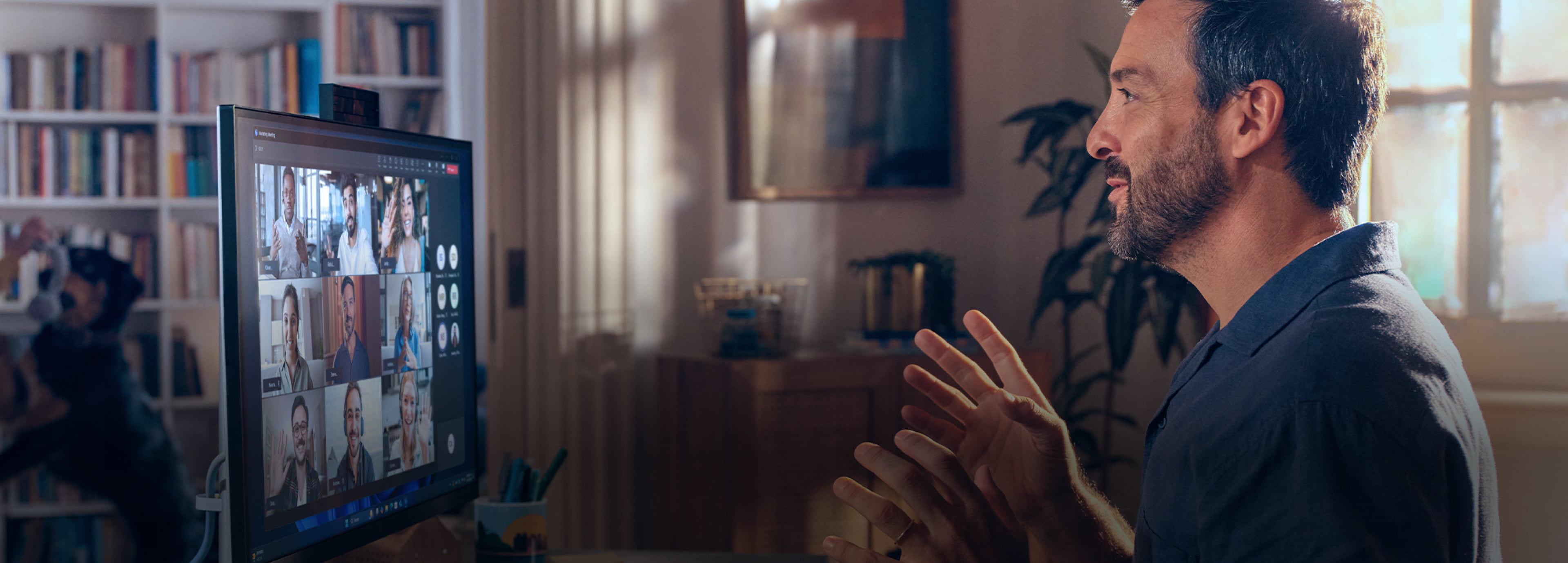 A man working from home on an HP EliteDesk AiO with his son by his side