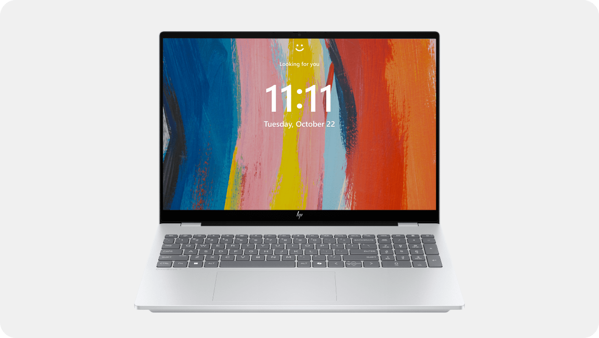 Open HP laptop displaying a colorful abstract background and the Windows 11 lock screen with the time "11:11" and date "Tuesday, October 22".