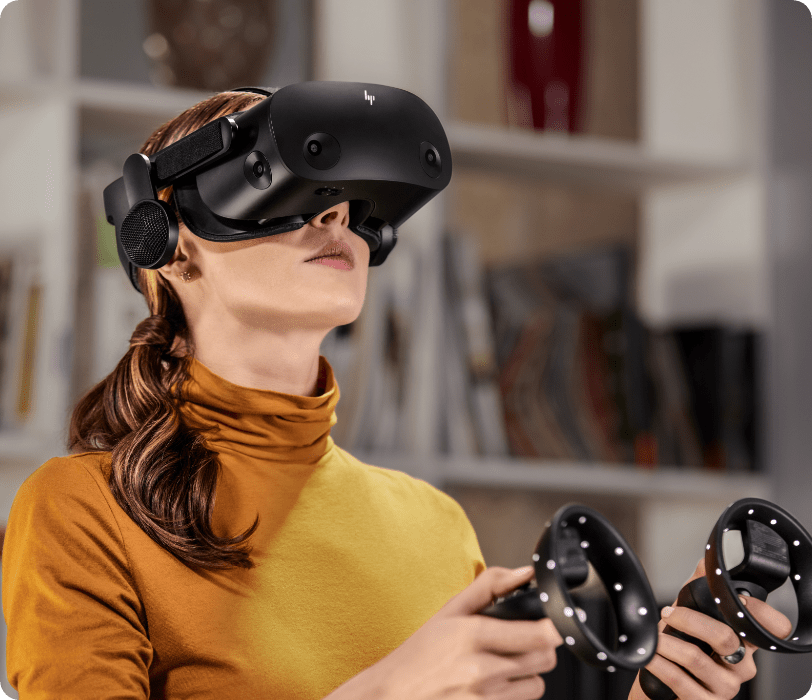 Woman using the HP Reverb G2 Virtual Reality Headset and controls