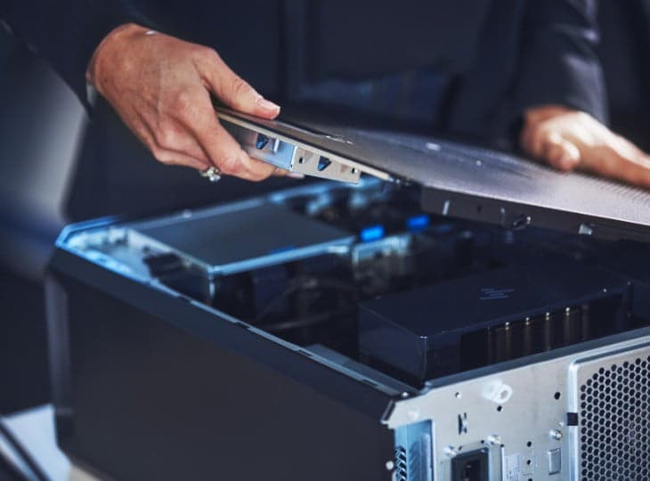Man opening the side panel of a Z Desktop workstation to access the internal components