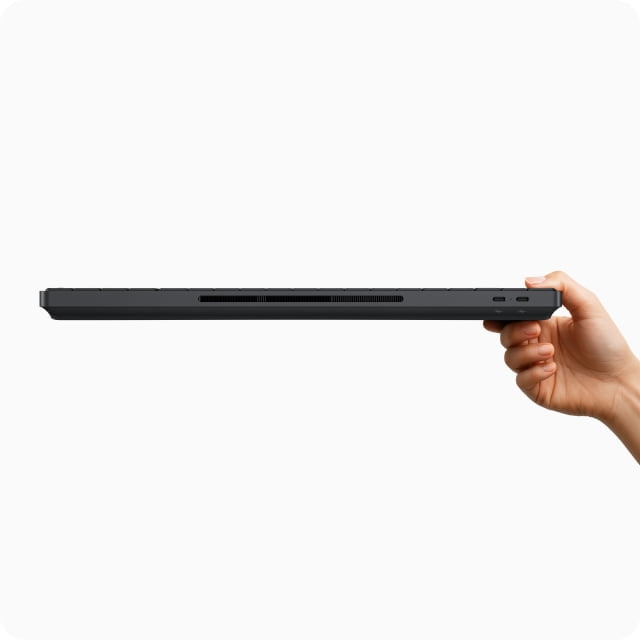 A side profile of the HP EliteBoard AI PC with a hand holding it up. 