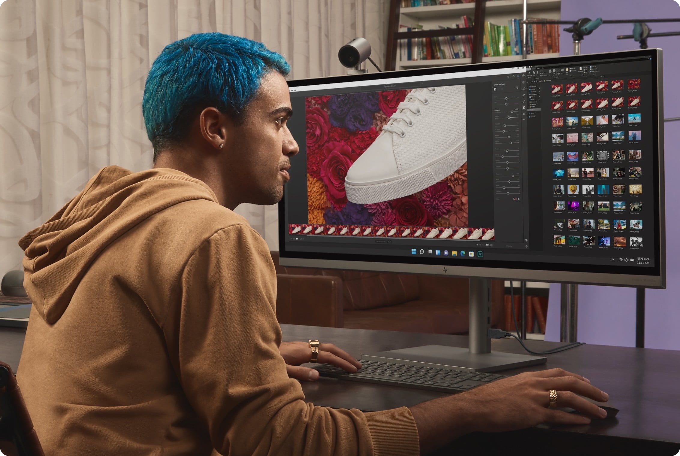 A man editing photos on an HP ENVY 34-inch All-in-One Desktop