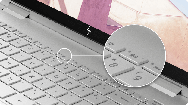 Close-up of the HP ENVY x360 keyboard, showing mute mic button
