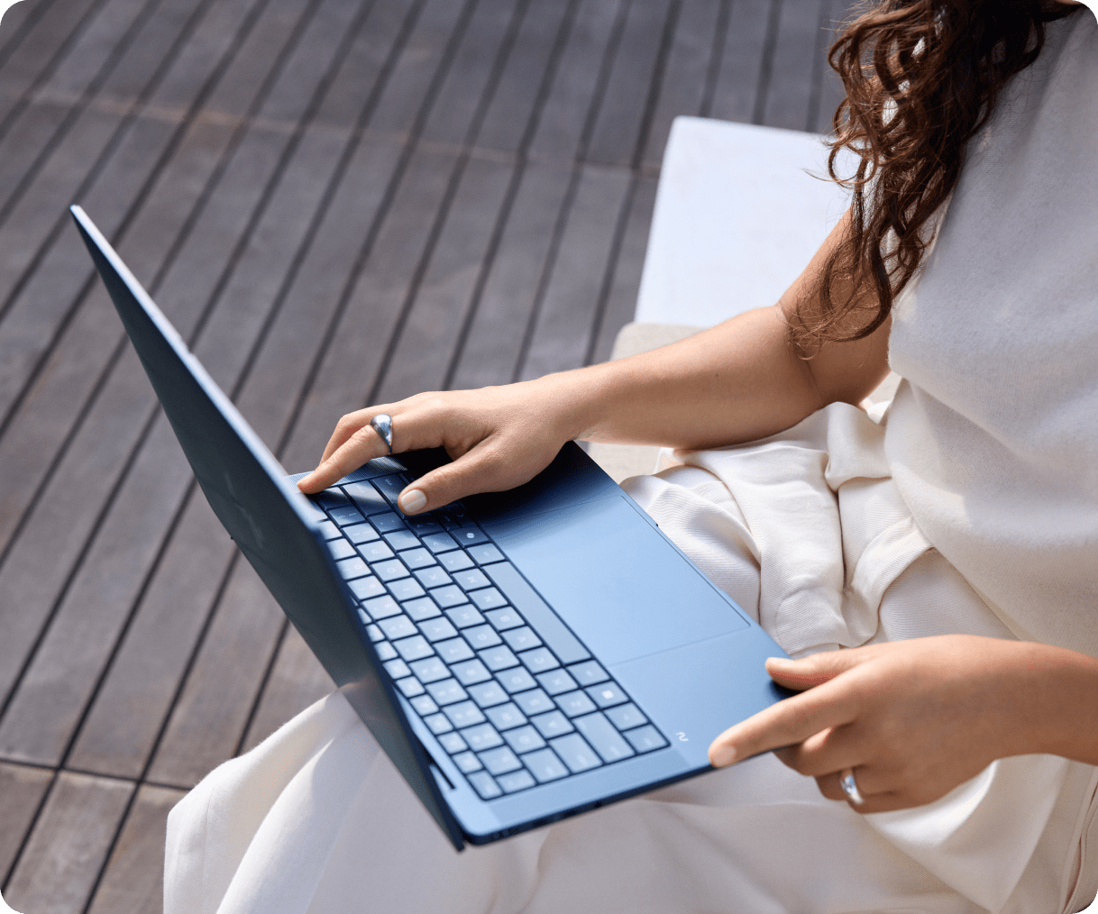 Woman working on an HP laptop from her patio.