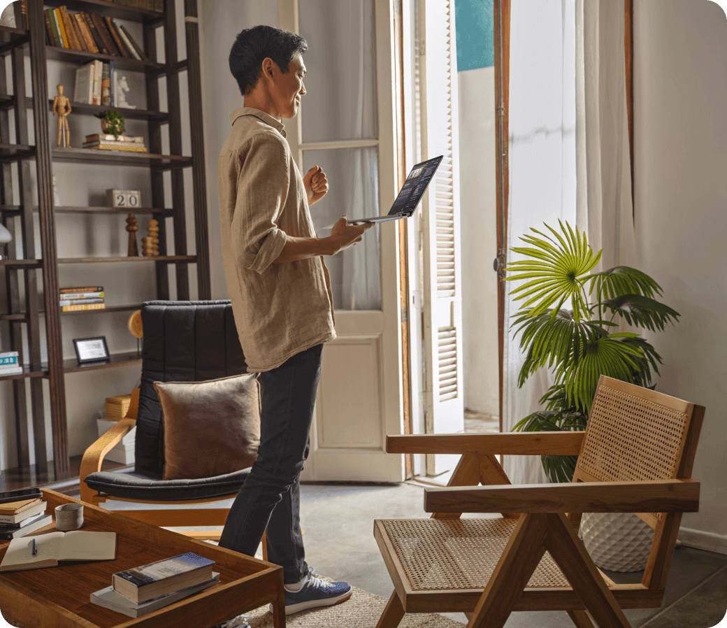 Person working comfortably with an HP laptop in a modern living space, reflecting adaptable solutions for everyday productivity.
