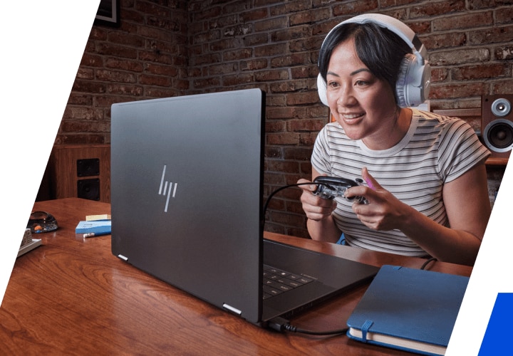 A woman playing on her HP laptop