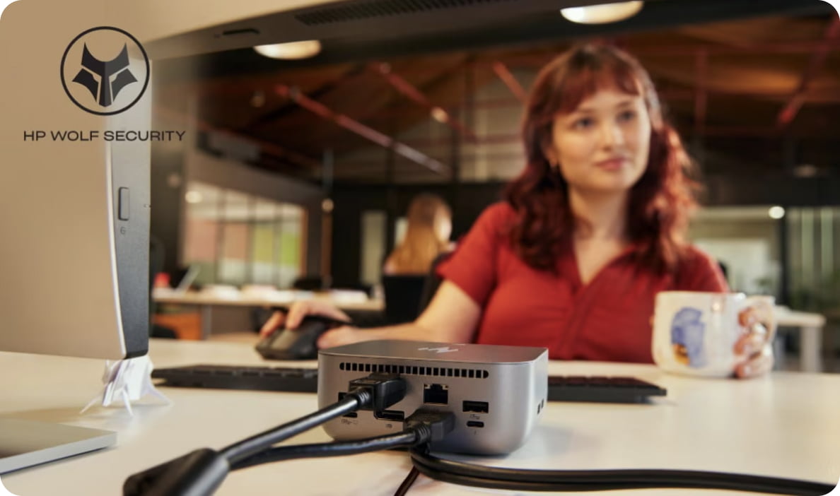 Person holding a mug using an HP dock for work.