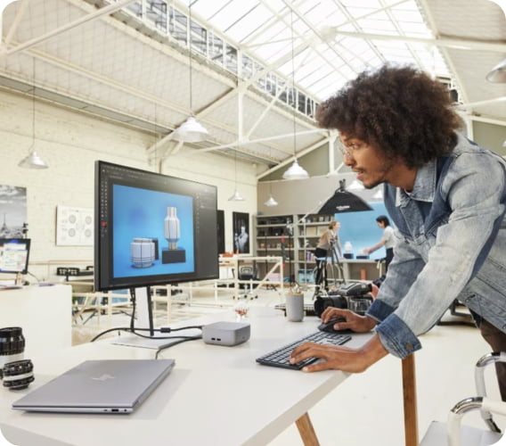 A person using HP Thunderbolt 4 Ultra 180W G6 Dock setup for work in a studio.