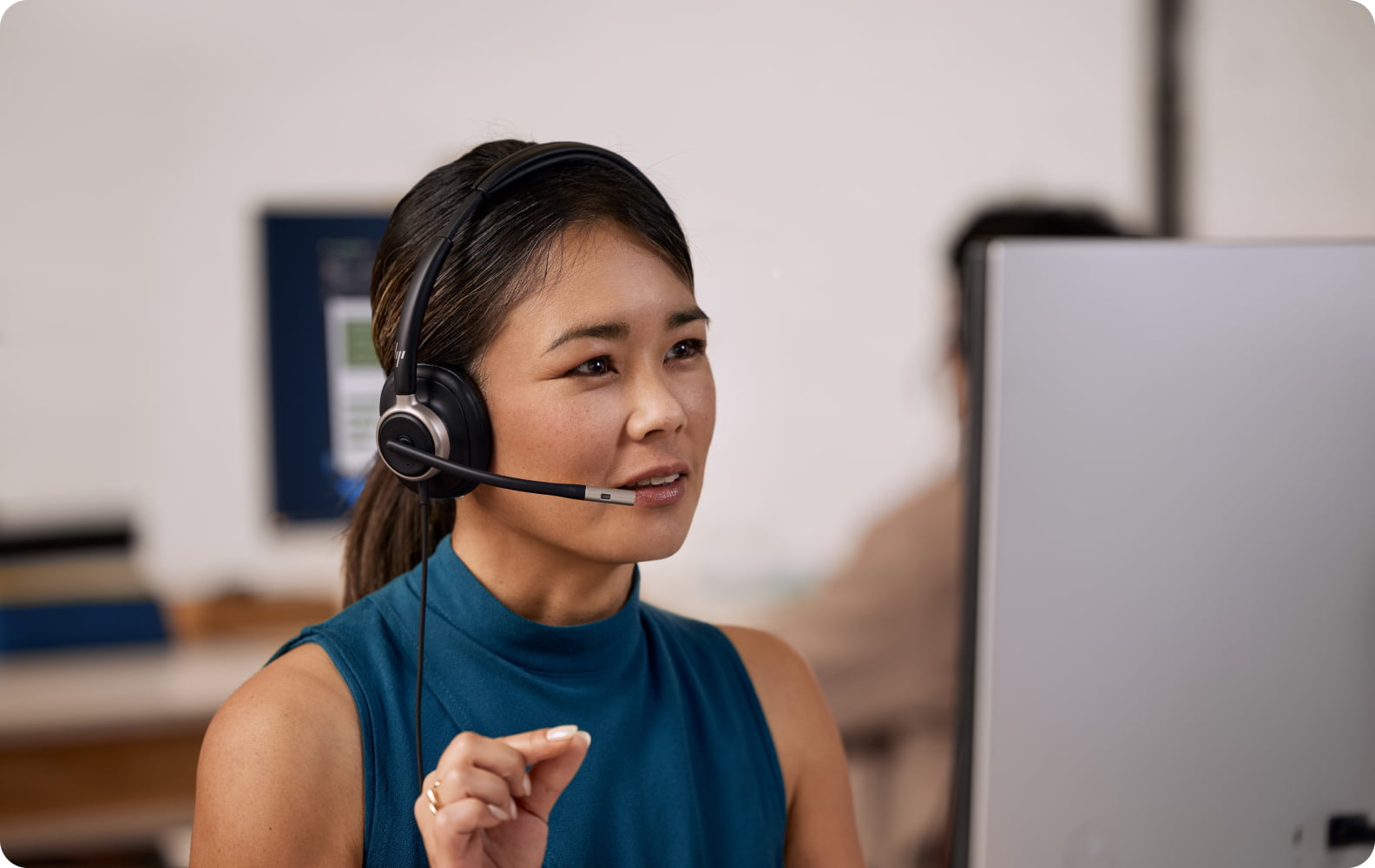 Professional woman wearing HP Poly Mission USB Series headset