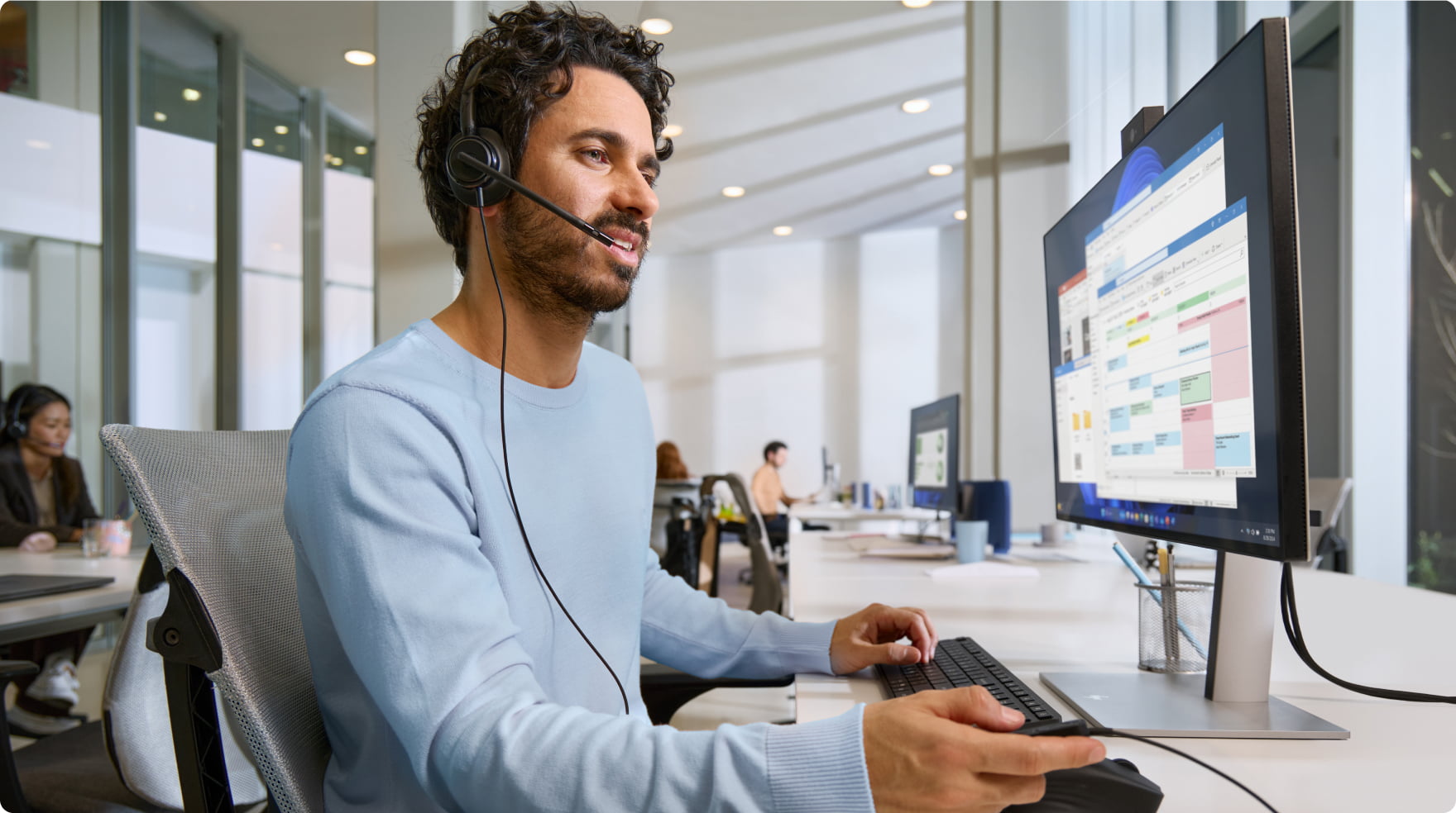 Worker at desk wearing HP Poly headset