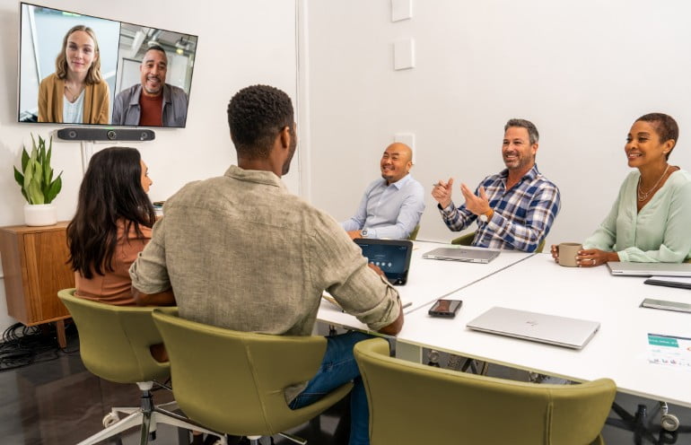 People in a meeting room on a video conference call