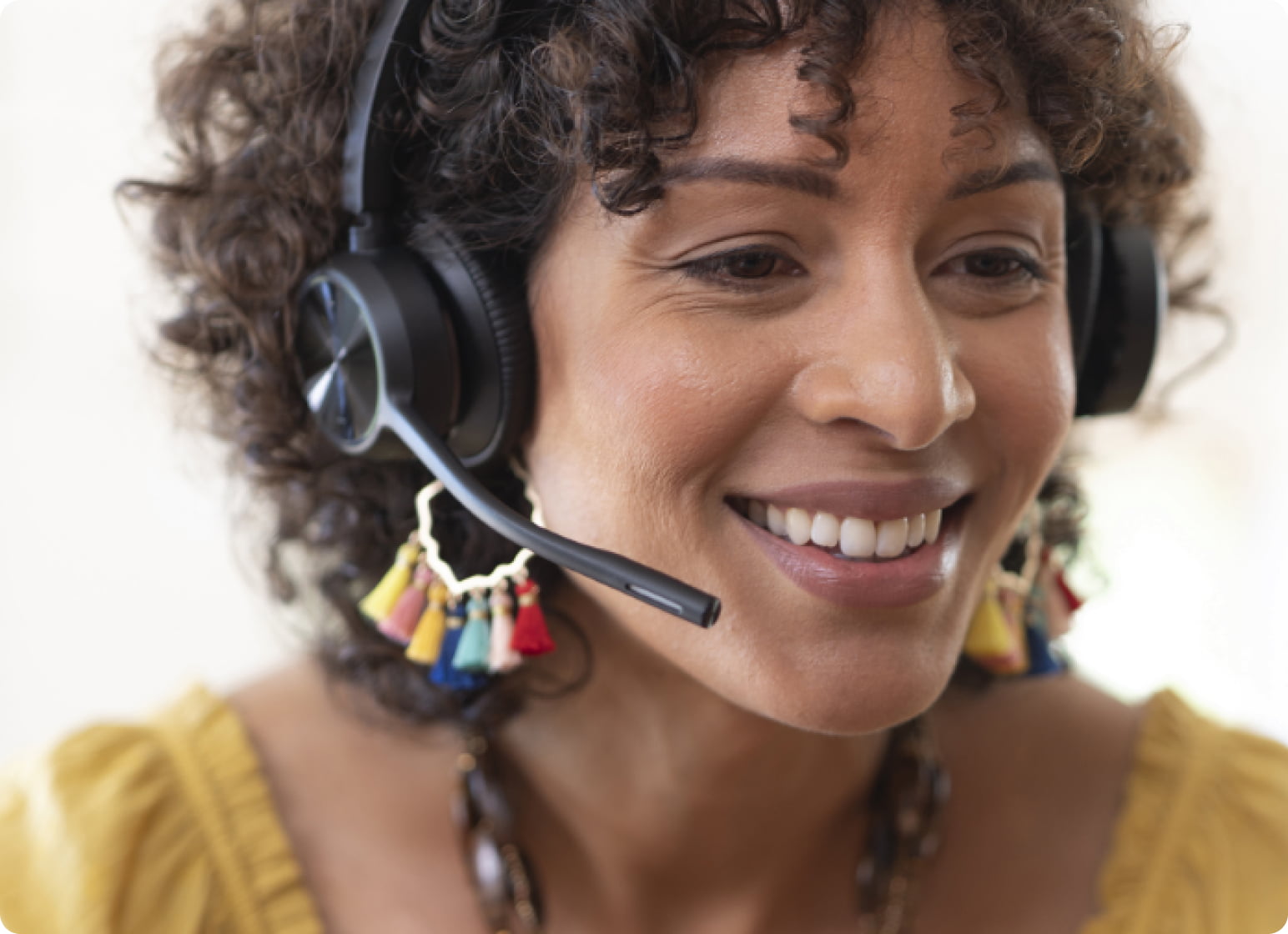 Woman smiling and wearing a headset.
