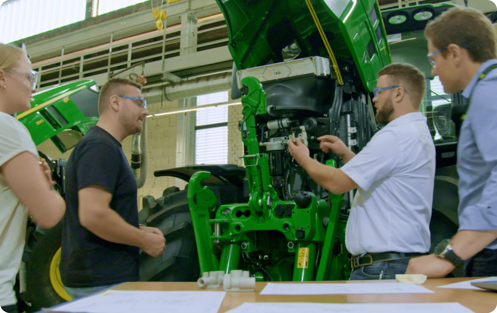 3D engineers at John Deere placing 3D part on a tractor