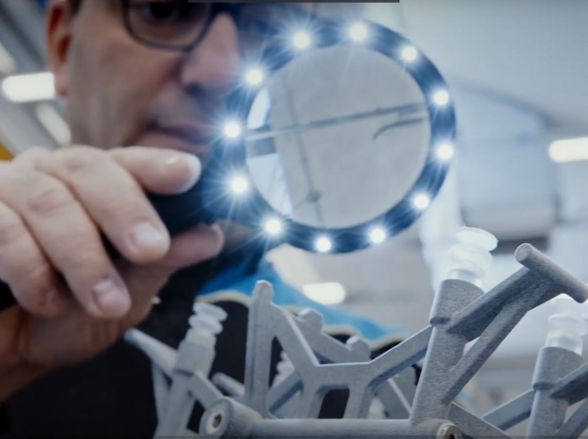 3D Printing engineer looking at 3D printed parts by Campetella Robotic Center