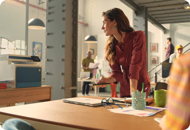 Female small business worker in creative office space printing to HP LaserJet from her phone app