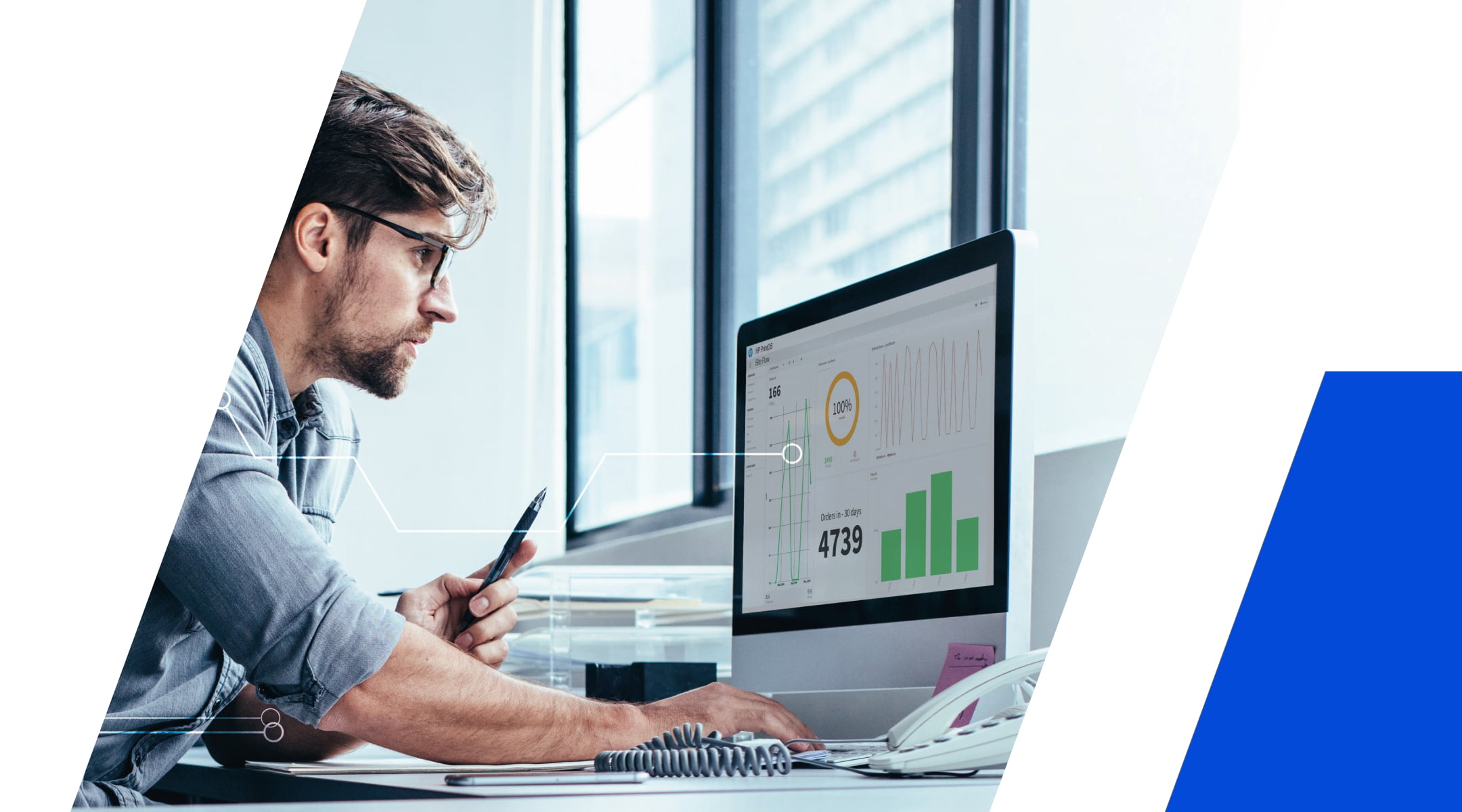 Person analyzing data dashboards on a desktop computer in a bright office.