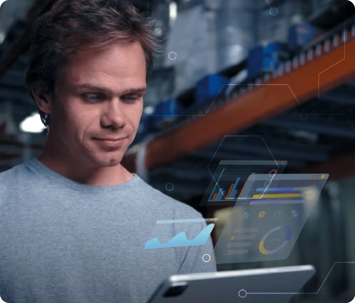 Person using a tablet in a warehouse with digital data graphics overlaid.