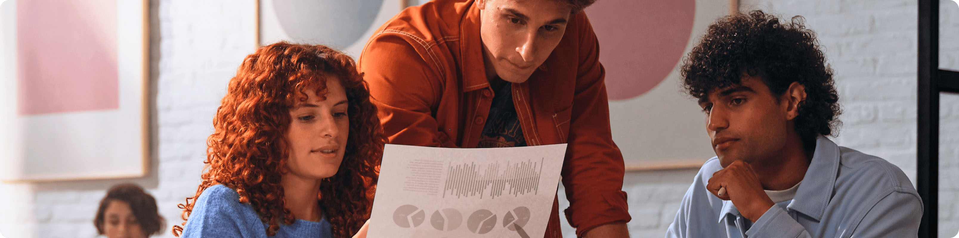 Collaborators reviewing printed reports from an HP printer for work.
