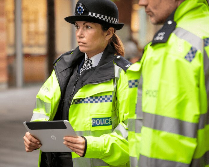 Policewoman and colleague with HP tablet