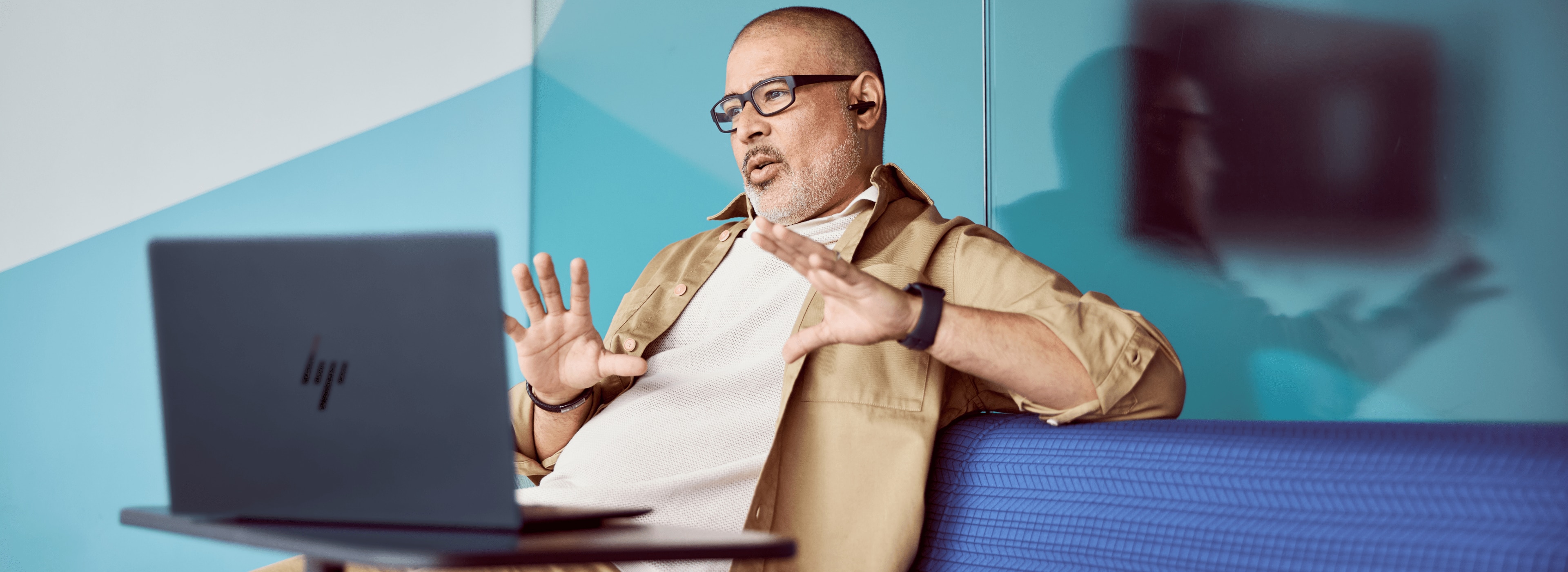 Worker in open office with meeting happening