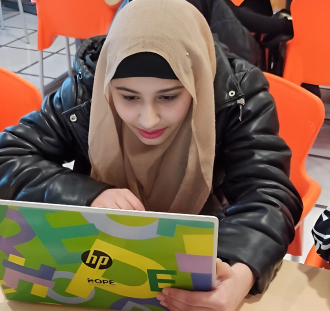 Children leaving school carrying HP laptops