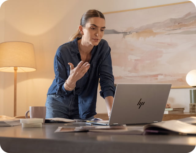 Woman professional in home office talking in a video conference call with her HP laptop