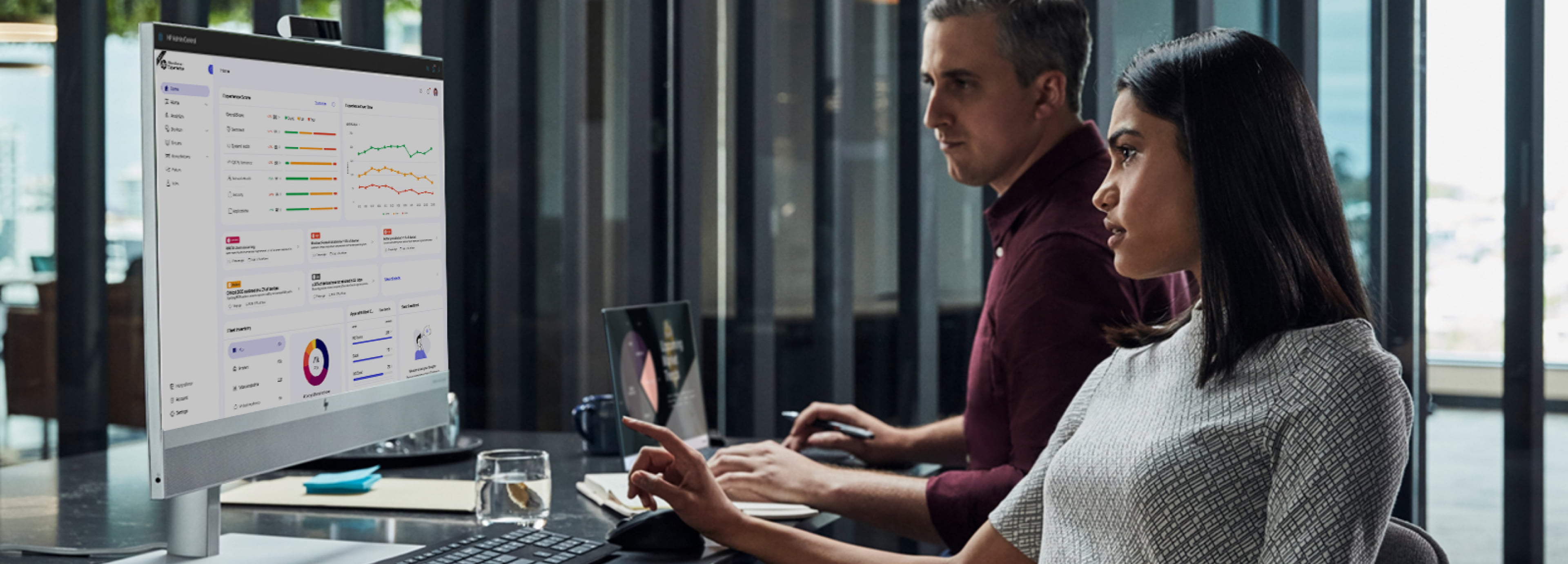 Employees look at dashboard on HP PC