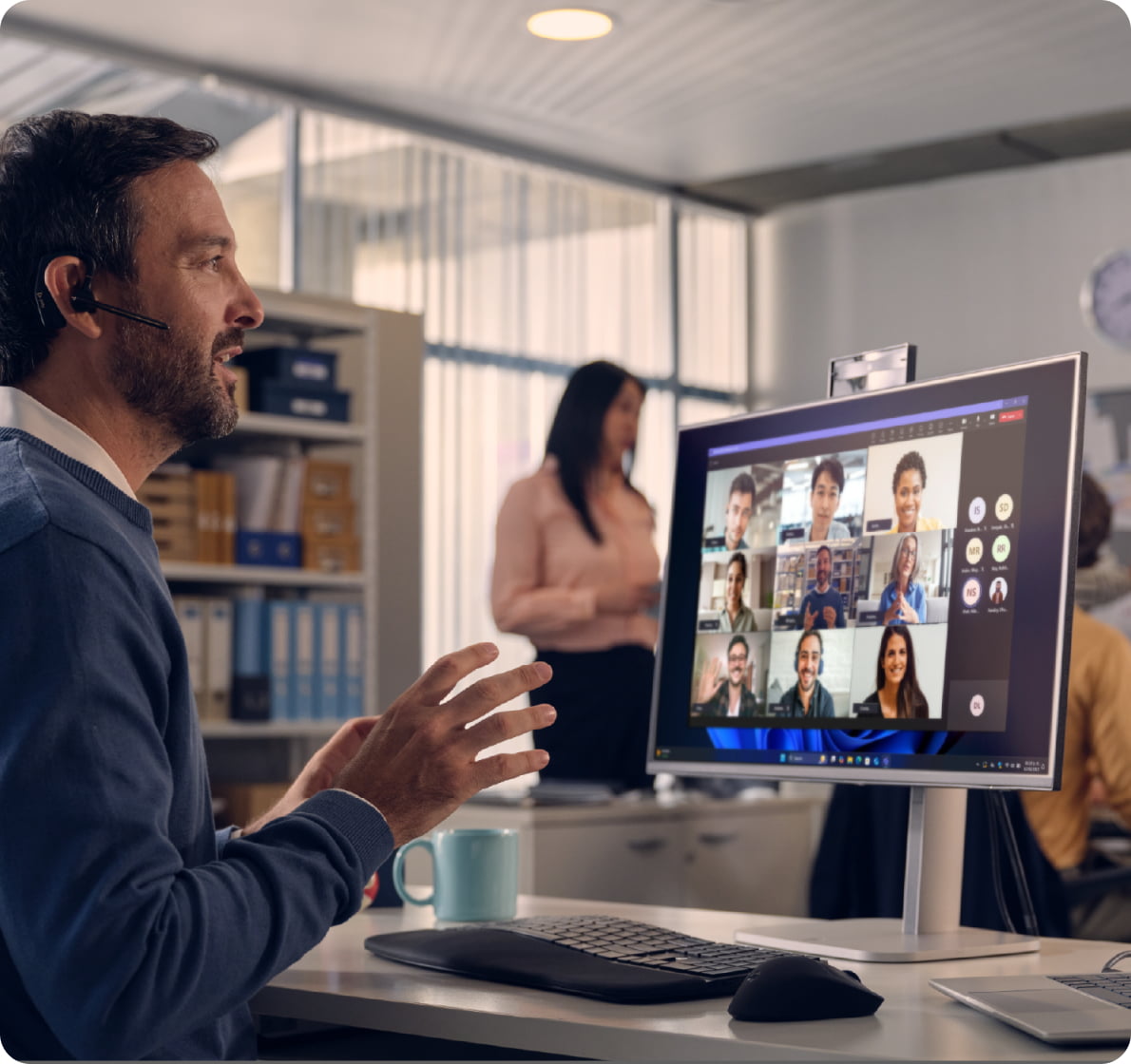 Office worker leading a virtual meeting on an HP desktop with video conferencing software, illustrating hybrid collaboration in a professional environment.