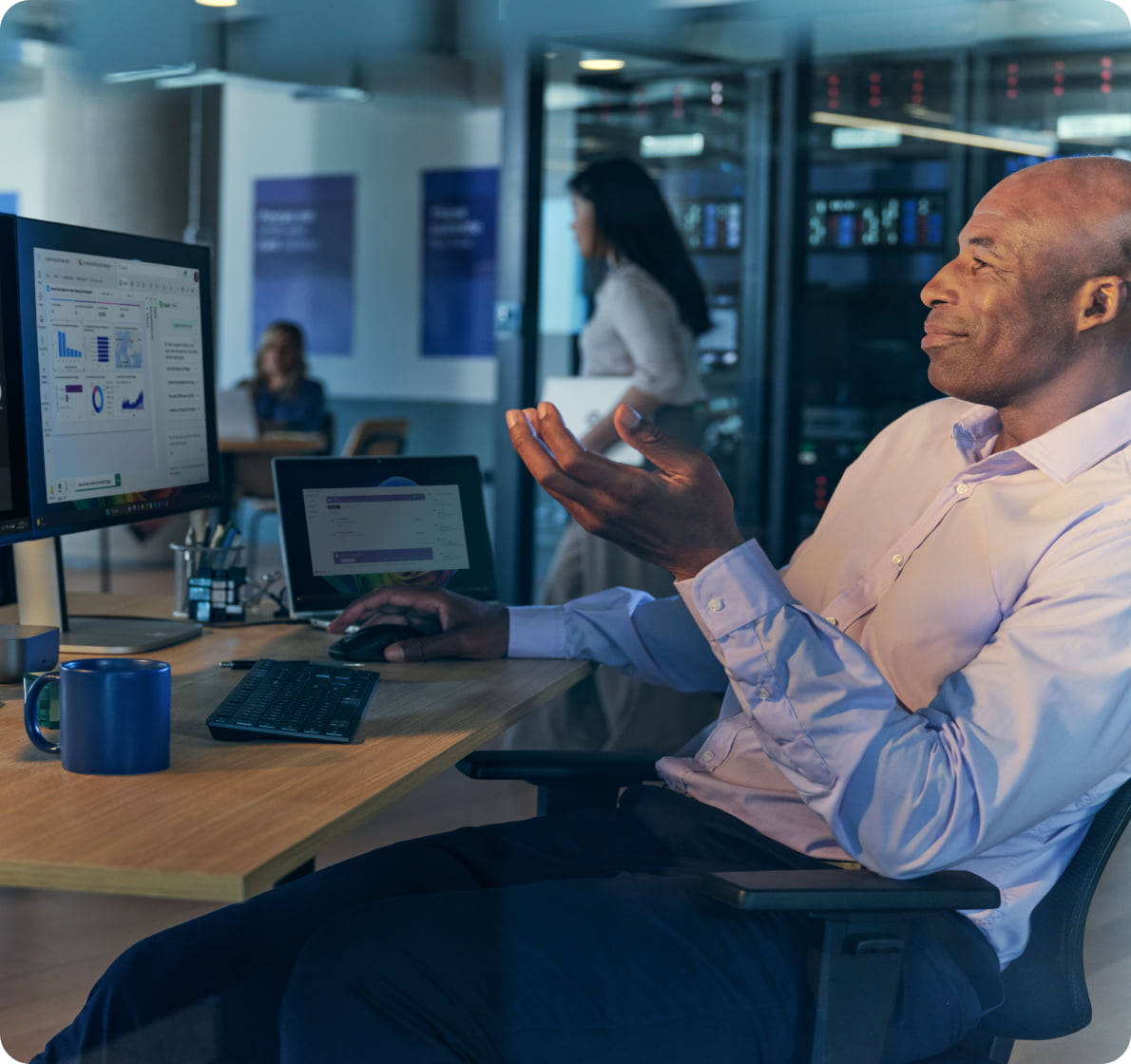 Professional participating in a video conference using dual HP monitors in a corporate office, highlighting multitasking and remote collaboration in a hybrid work environment.