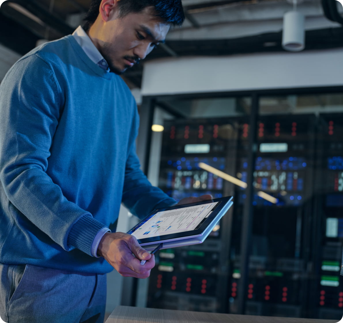 IT professional working on data analysis using dual HP monitors and a laptop in a home office setup, illustrating productivity, security and remote work flexibility.