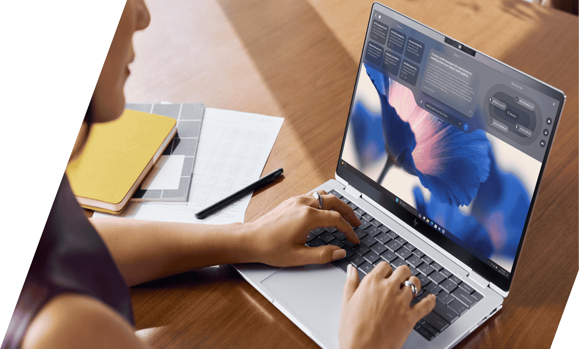 Looking over the shoulder of a man working with an HP EliteBoard and portable monitor.