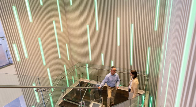 HP employees chatting on stairs.