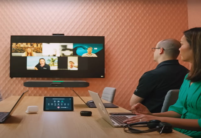 modern professionals in a conference room using HP Poly collaboration devices for a video conference call