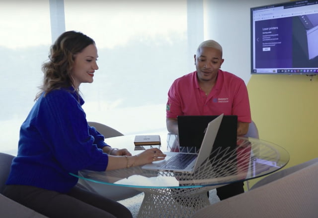Male and female professionals collaborating in a small modern conference room