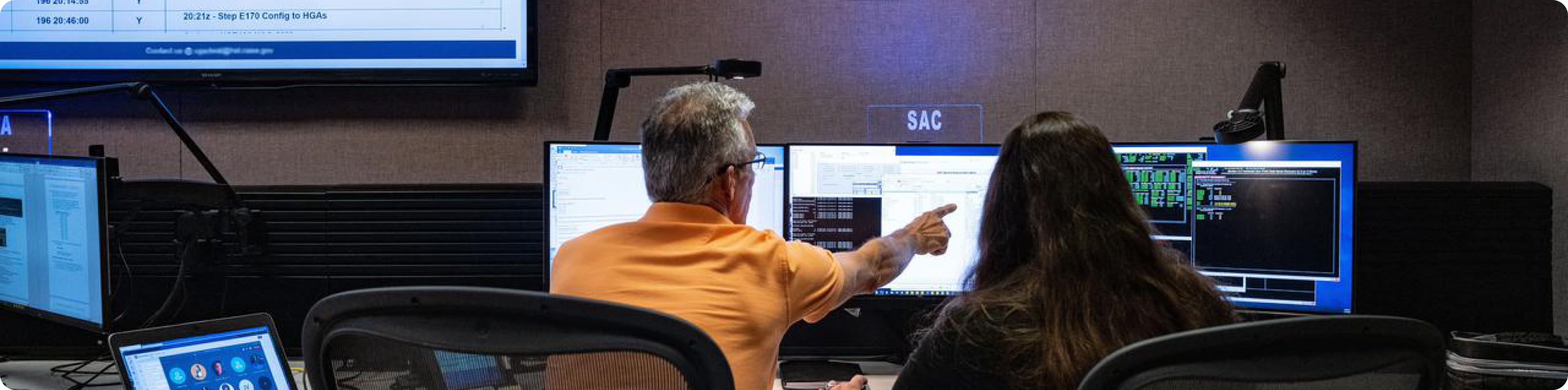 Two individuals working together in Mission Control 