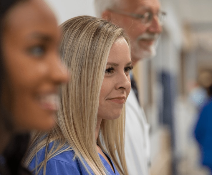 Three healthcare IT employees shown in close profile