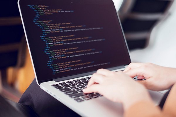 Programmer Coding on Laptop