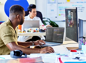 Man working in front of an HP monitor connected to a ZBook mobile workstation PC.