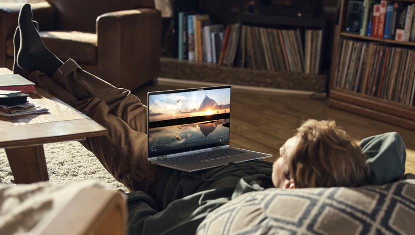 image of guy laying back and work with a  premium laptop