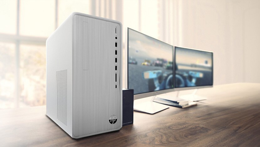 a tower on a desk with dual monitor setup