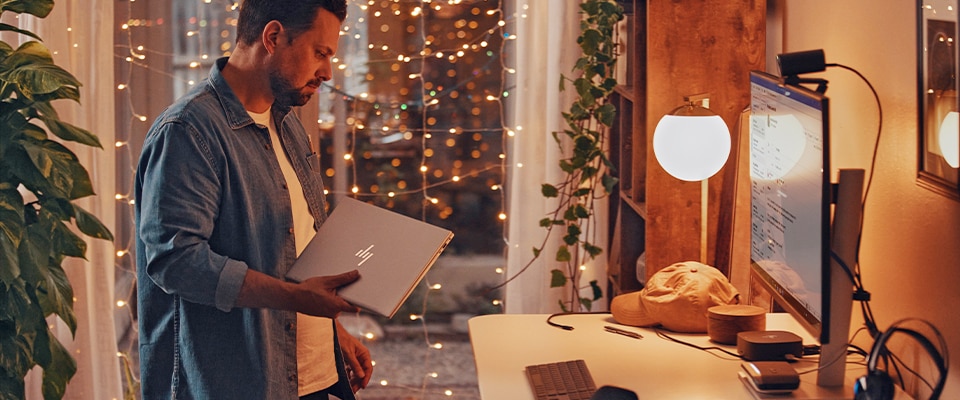 person in a home office with holiday lighting decoration