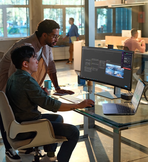 Two men in office working on a desk with an HP products setup